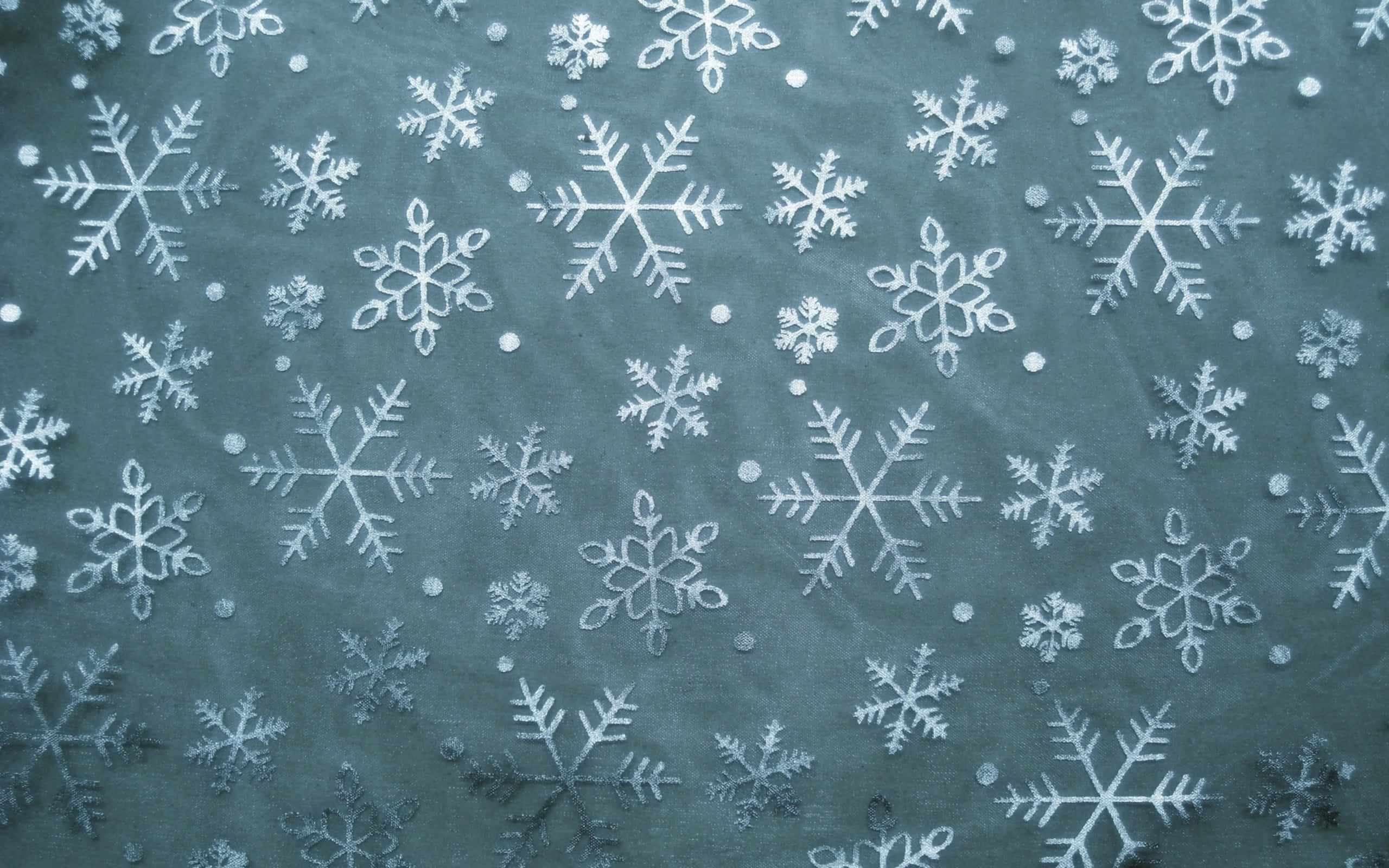 帶有白色雪花和圓點圖案的青綠色布料