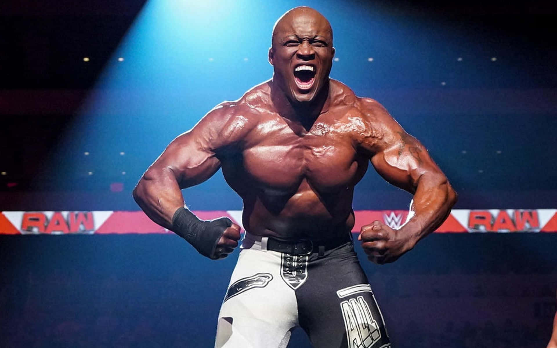 摔角手在藍色聚光燈下於WWE RAW舞台上咆哮。