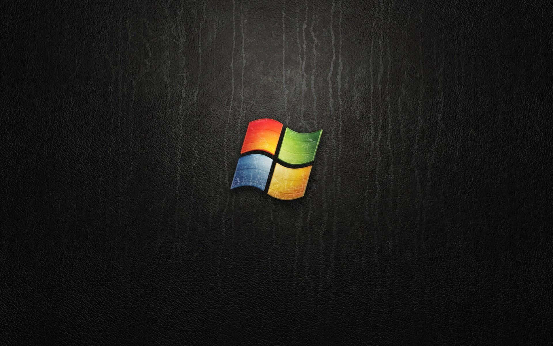 Windows Vista 桌布 壁紙 — 鮮豔的Windows標誌在帶有微妙垂直條紋的紋理黑色皮革背景上發光。