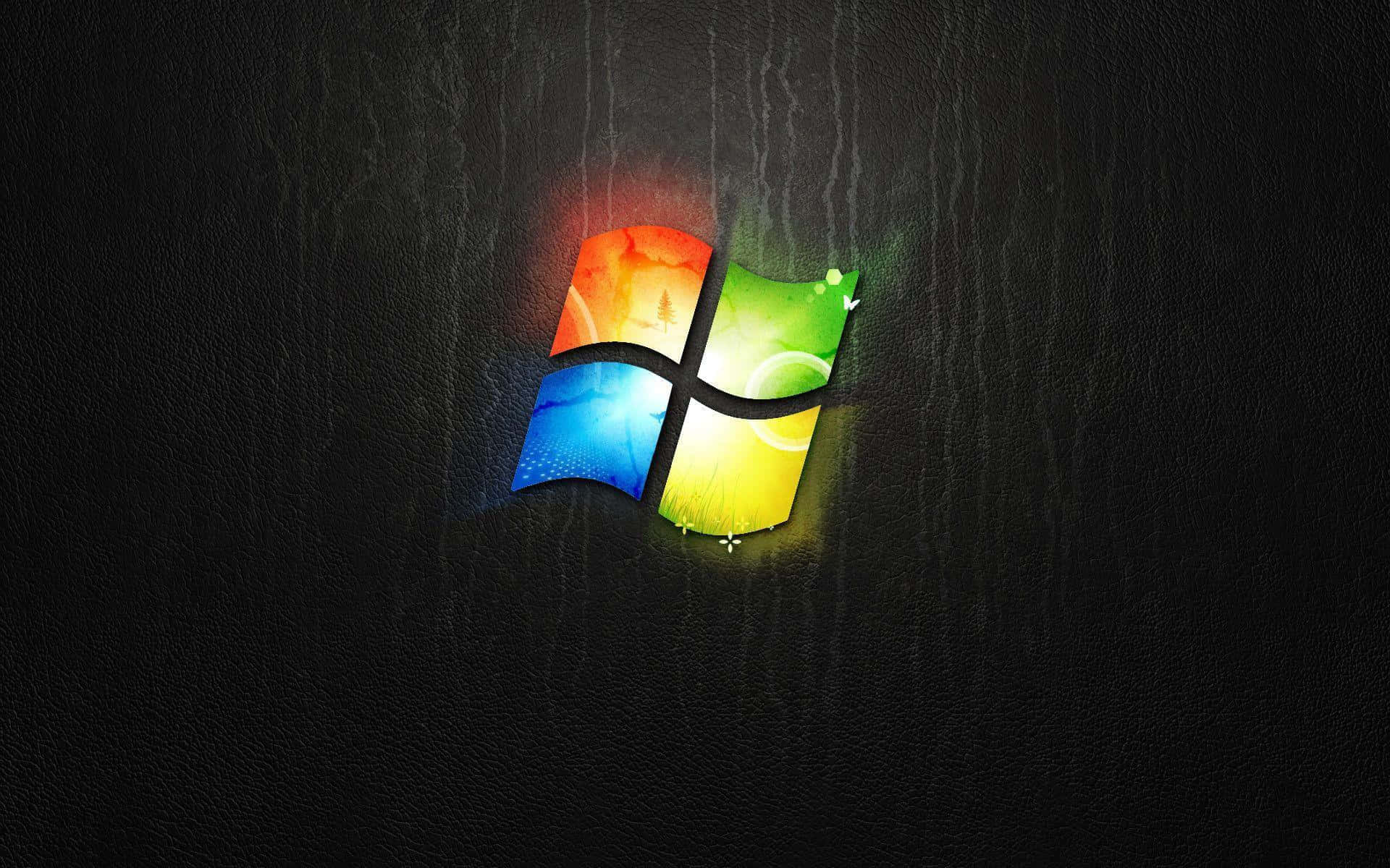 Cool Desktop 桌布 壁紙 — 鮮豔的Windows標誌在深色紋理背景上散發出彩虹色調的光芒。