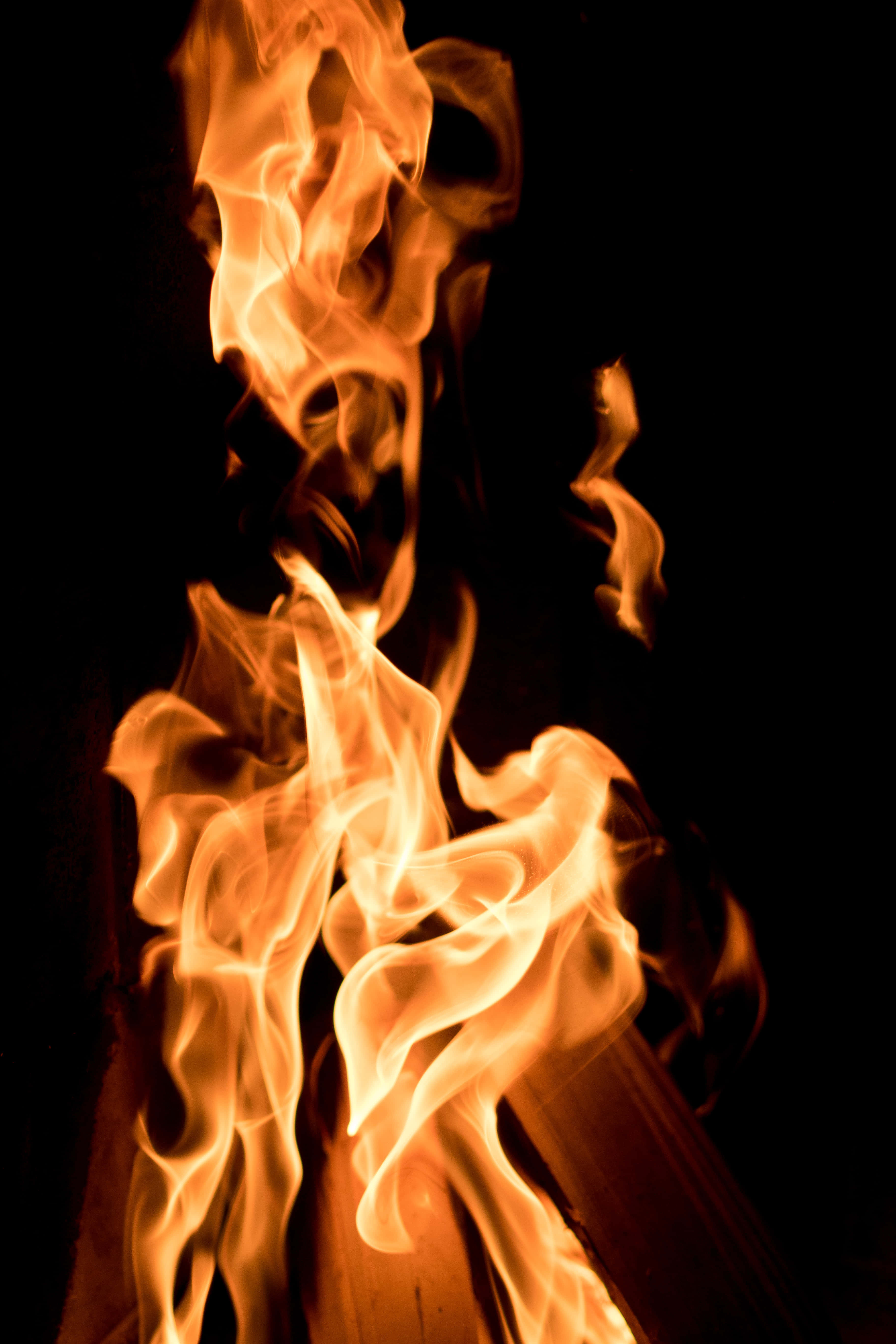 Burn 桌布 壁紙 — 鮮豔的橙色和黃色火焰在純黑色背景上伴隨著發光的餘燼動態舞動。