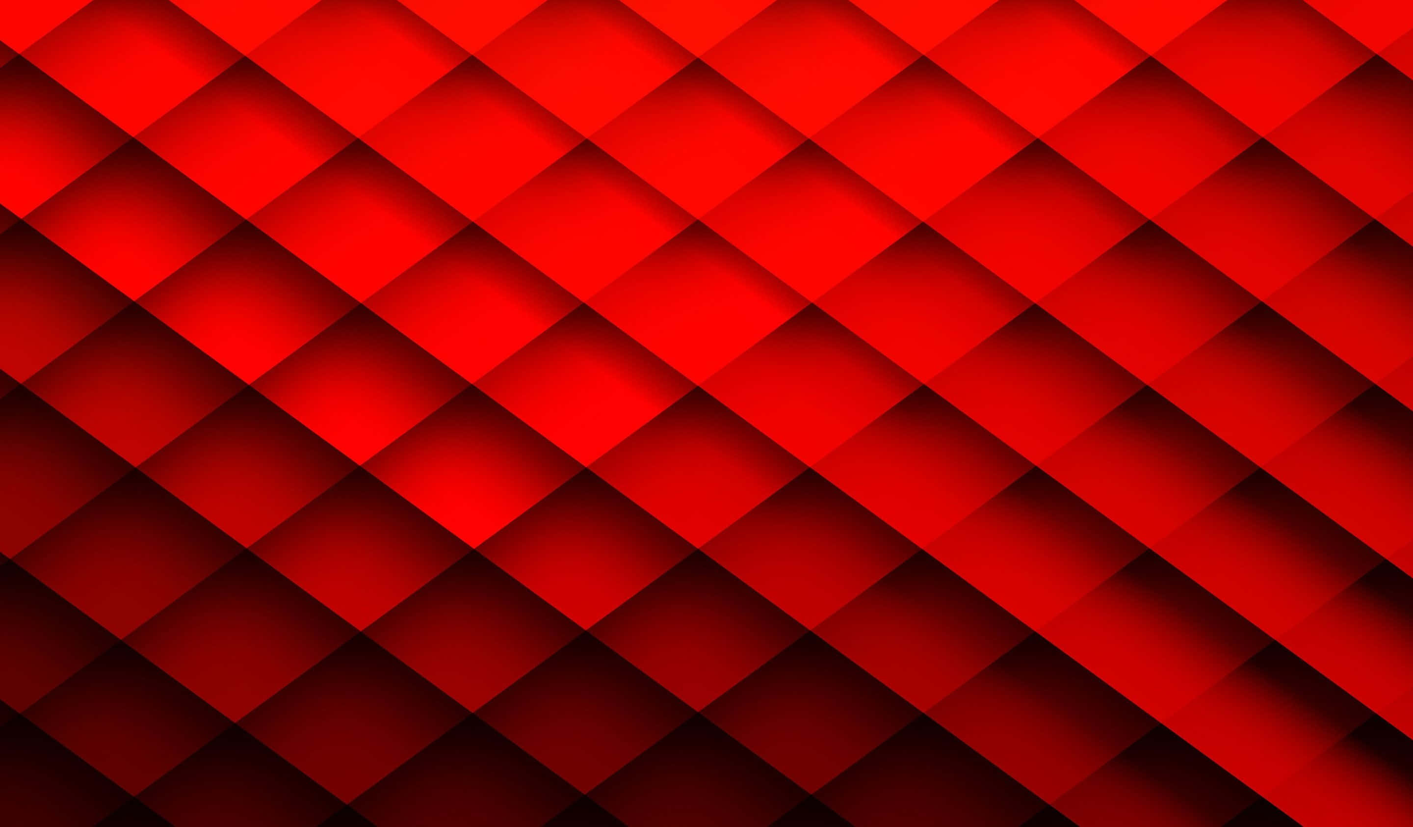 Red Abstract 桌布 壁紙 — 鮮豔的紅色幾何圖案，由重疊的菱形形狀組成，透過漸變陰影營造出動態的3D效果。