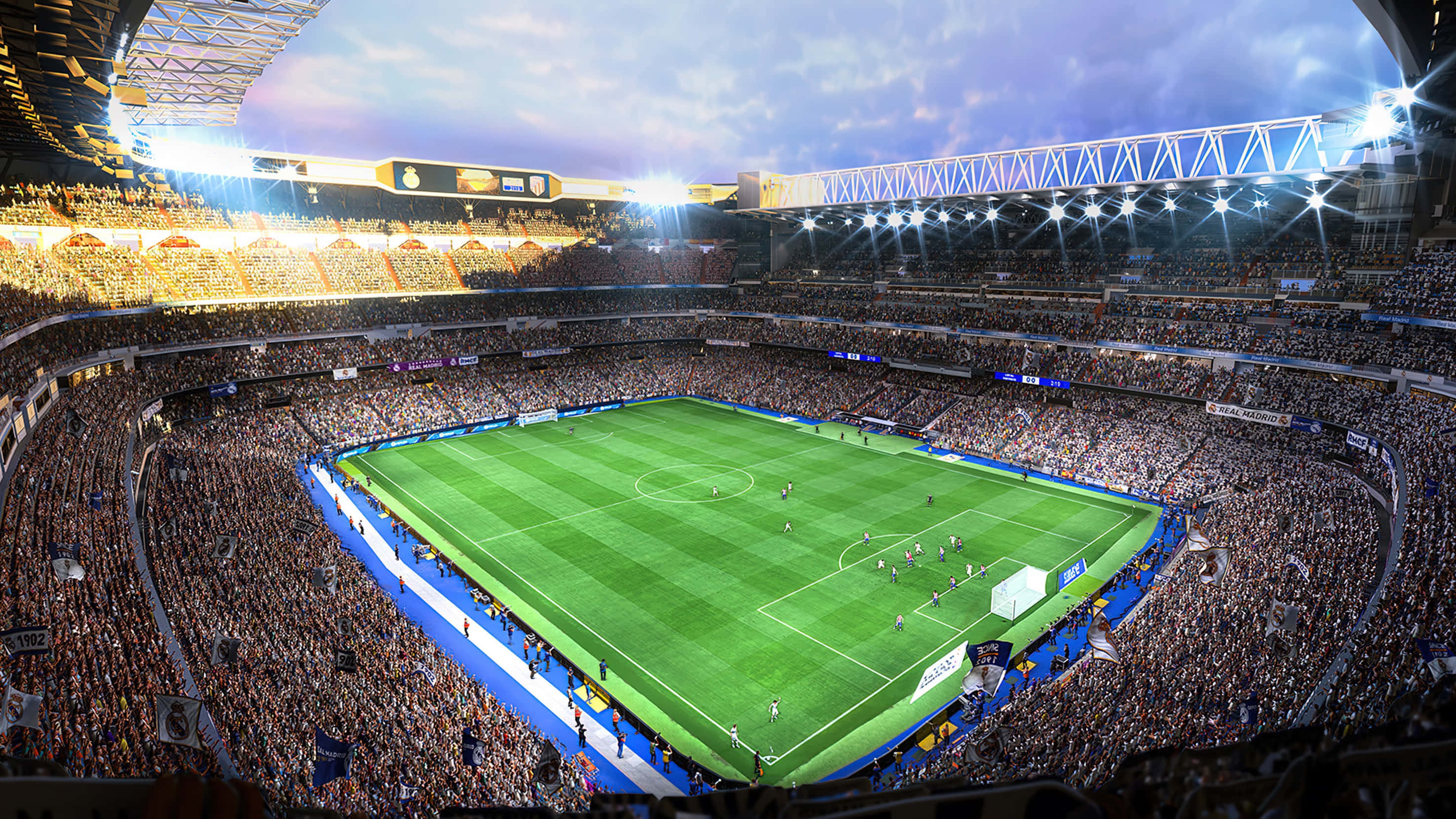 Soccer Stadium 桌布 壁紙 — 黃昏時分擠滿人的足球場鳥瞰圖，充滿活力的綠色球場和發光的泛光燈照亮了歡呼的球迷。