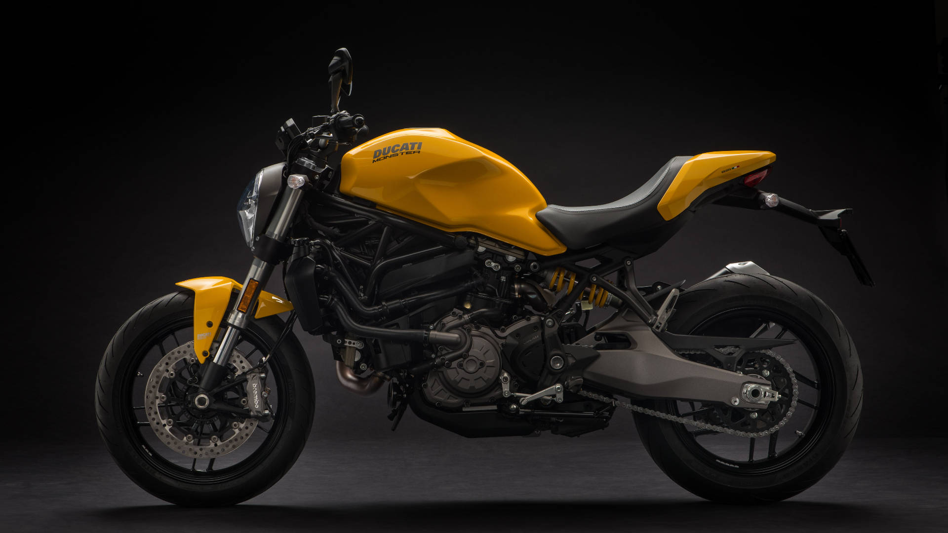 黃色Ducati電單車在攝影棚中，帶有黑色點綴和詳細的機械部件。