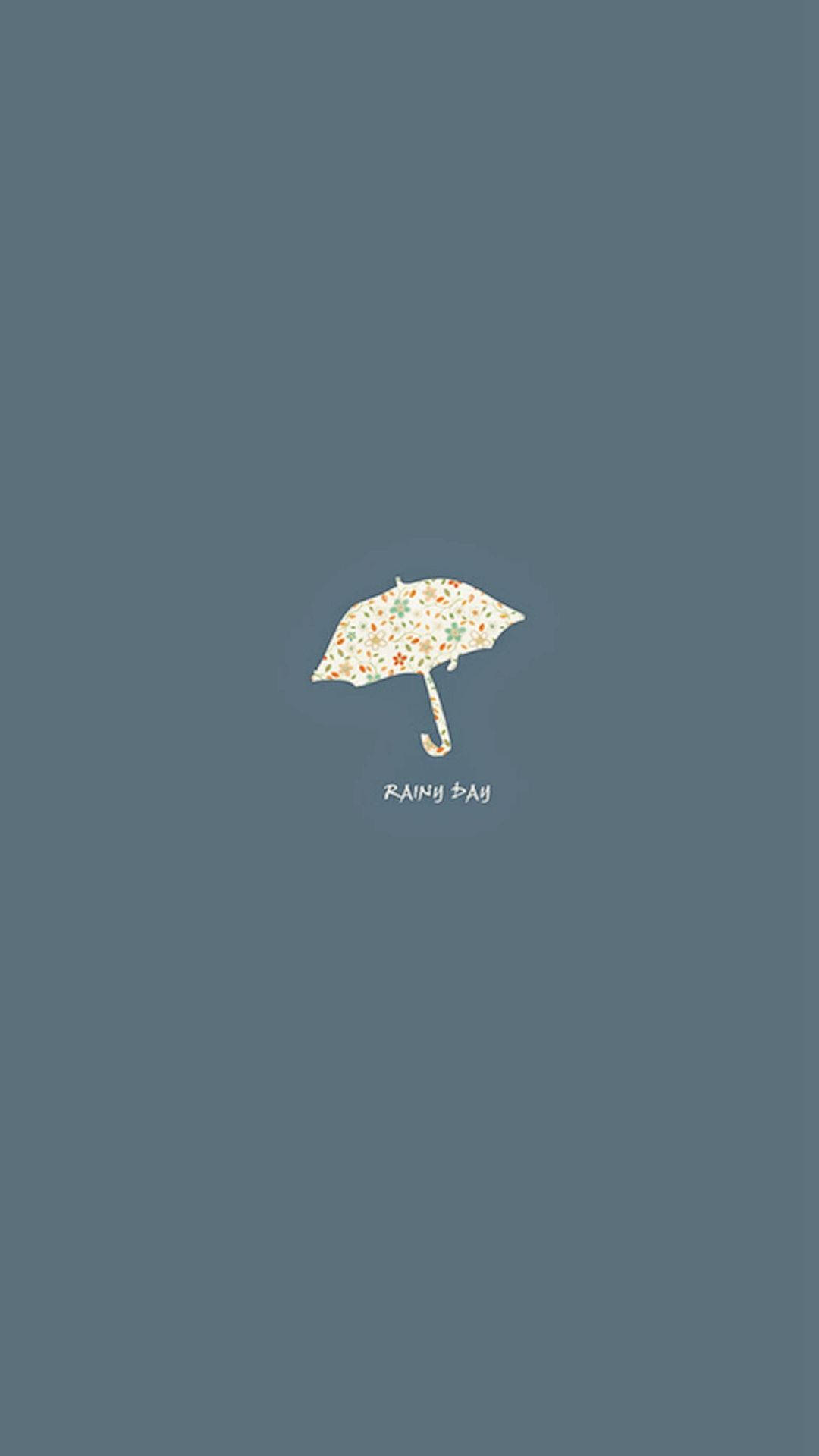 純色藍灰色背景上，一把帶有花卉圖案的雨傘和「RAINY DAY」文字。