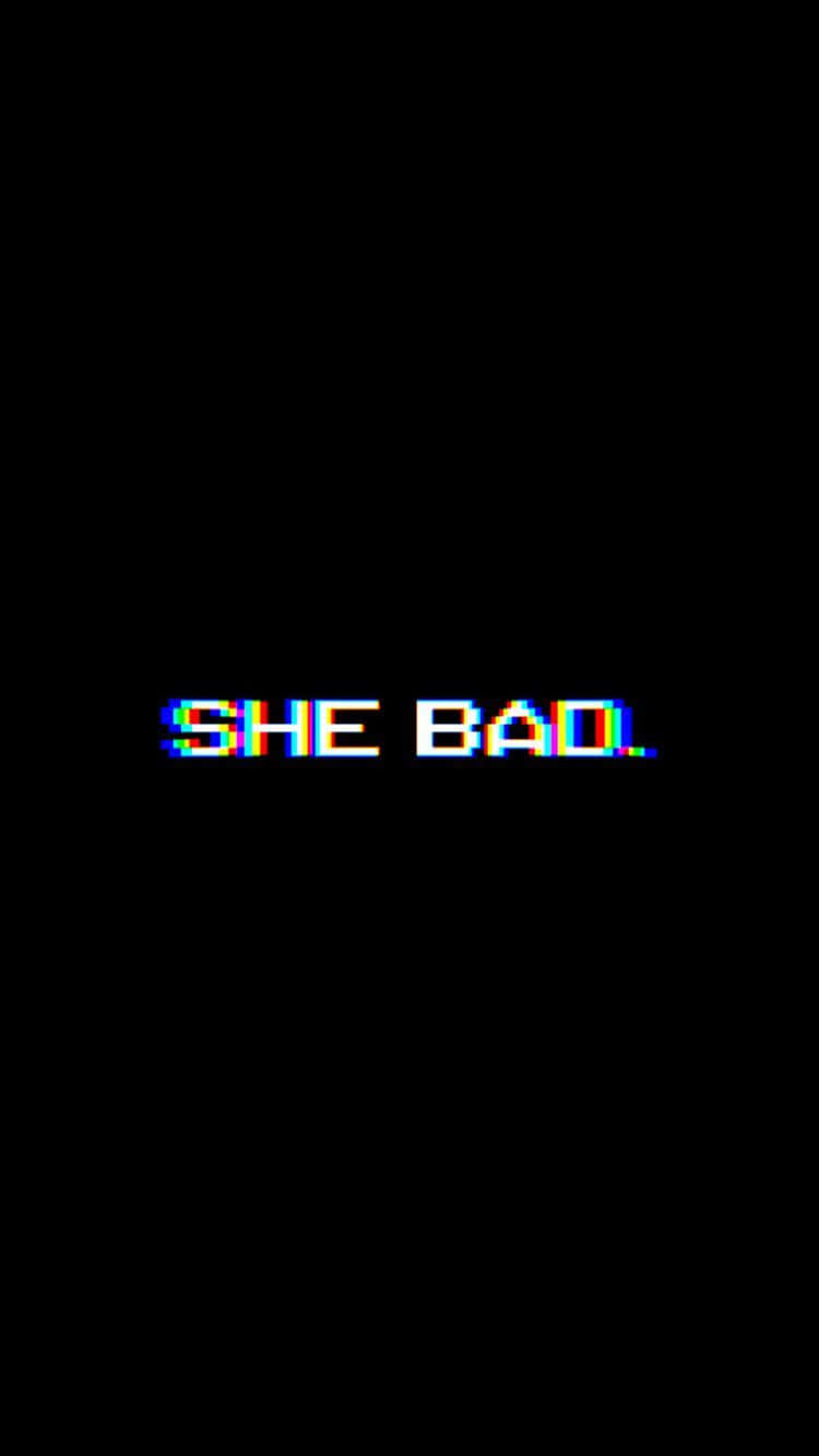 故障像素文字寫著「SHE BAD」，在黑色背景上有彩虹色彩失真。