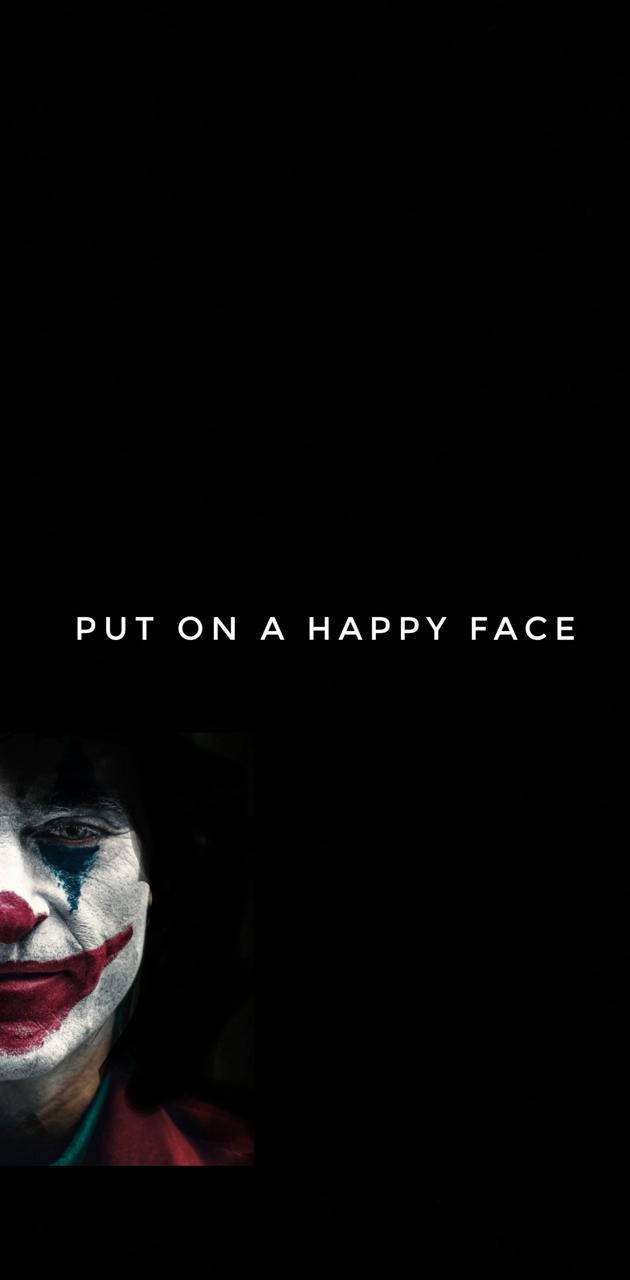 一個帶有紅色嘴唇和藍色眼淚的可怕小丑，從黑暗中的「put on a happy face」文字下方向上凝視。