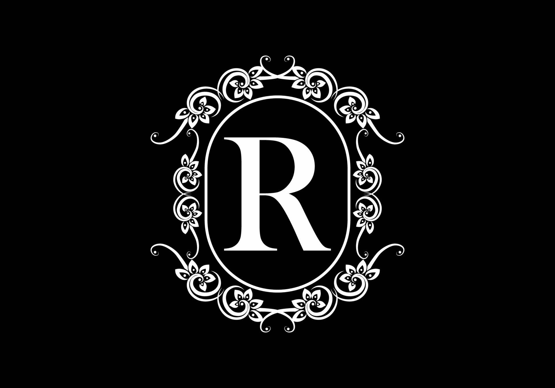 黑白精緻字母R 壁紙 — 一個大膽的白色字母R，在帶有花卉漩渦的華麗圓形框架中，在純黑色背景上脫穎而出。