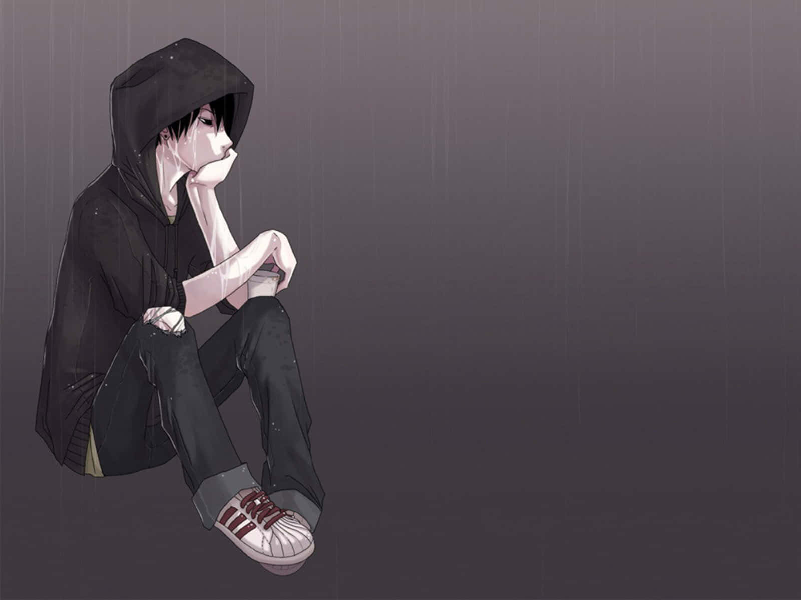 穿著黑色連帽衫的悲傷動漫男孩獨自坐在雨中