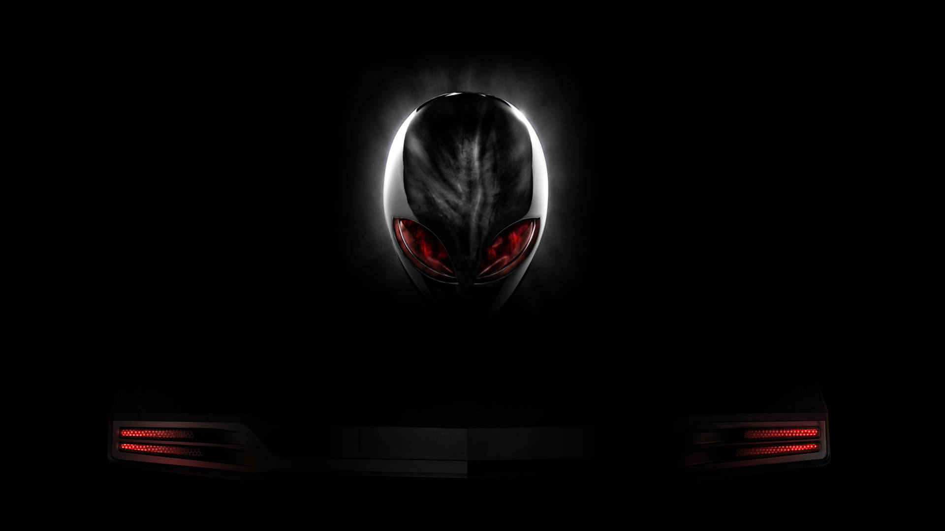 黑色 Alienware 標誌 壁紙 — 一個發光的外星人頭顱，帶有紅色眼睛，從黑暗中浮現，位於一部帶有紅色LED燈的纖薄筆記型電腦上方。