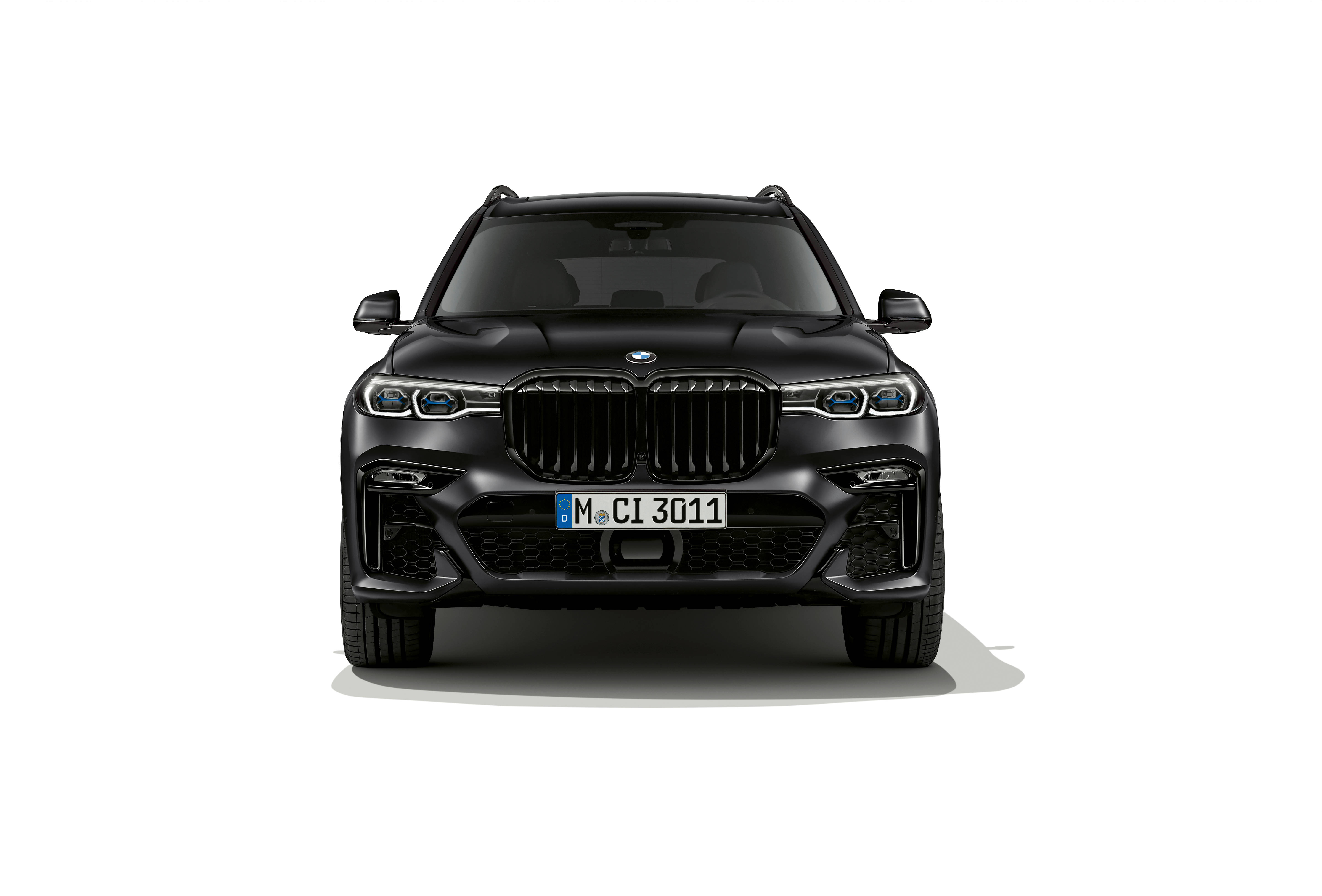 黑色BMW X7 壁紙 — 一輛時尚的黑色BMW X7 SUV正面朝前，配備銳利頭燈和標誌性格柵，背景為潔白。