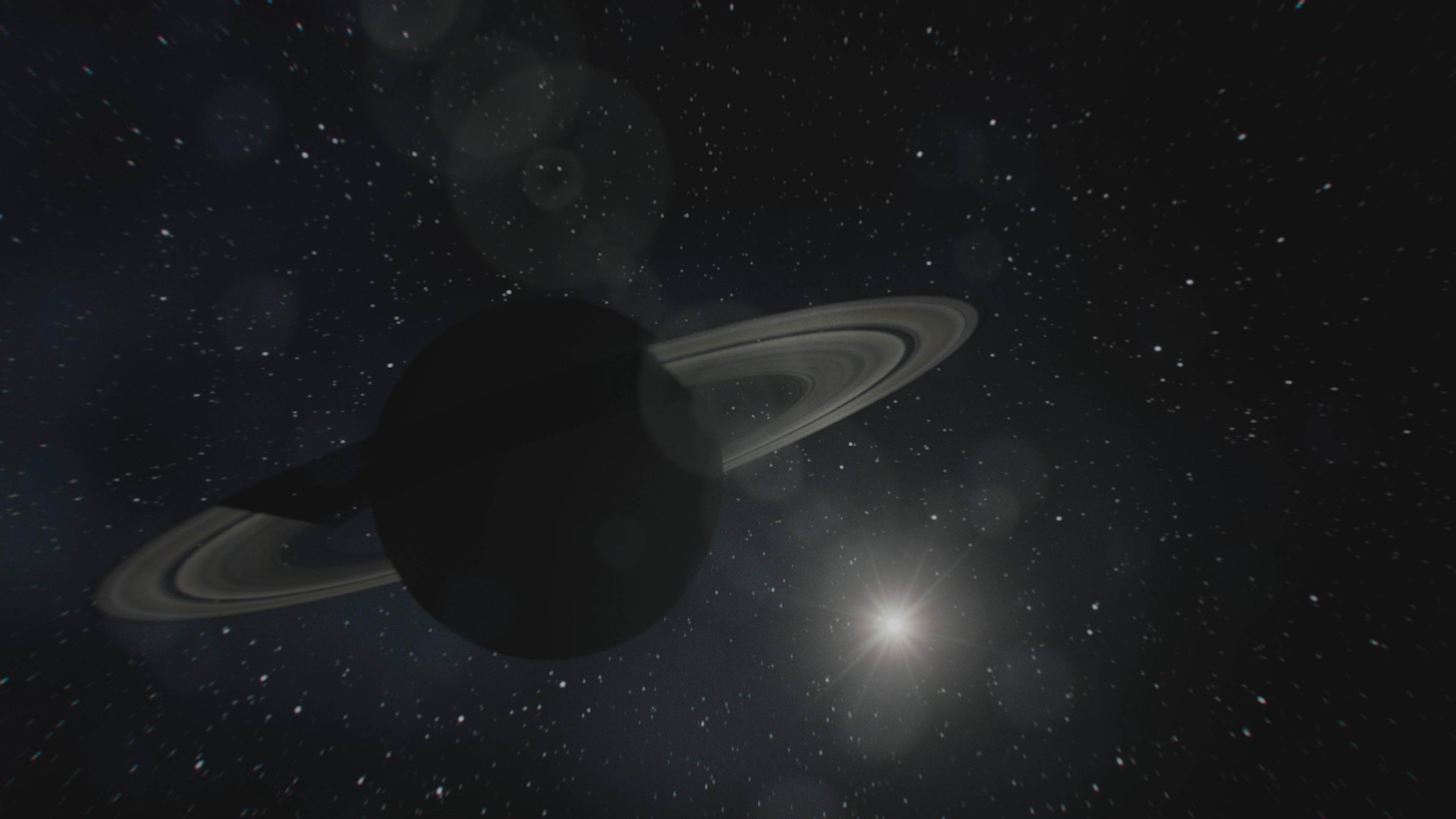 黑色土星與繁星 壁紙 — 一顆雄偉的土星帶有其標誌性的光環，在星空中柔和地發光，附近有一顆明亮的星星閃耀。