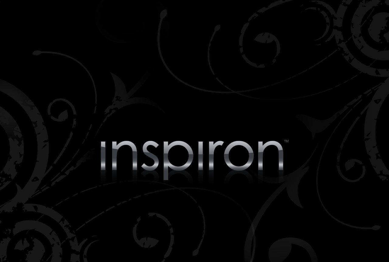 銀色 'inspiron' 標誌帶倒影，位於帶有灰色漩渦的黑色背景上。