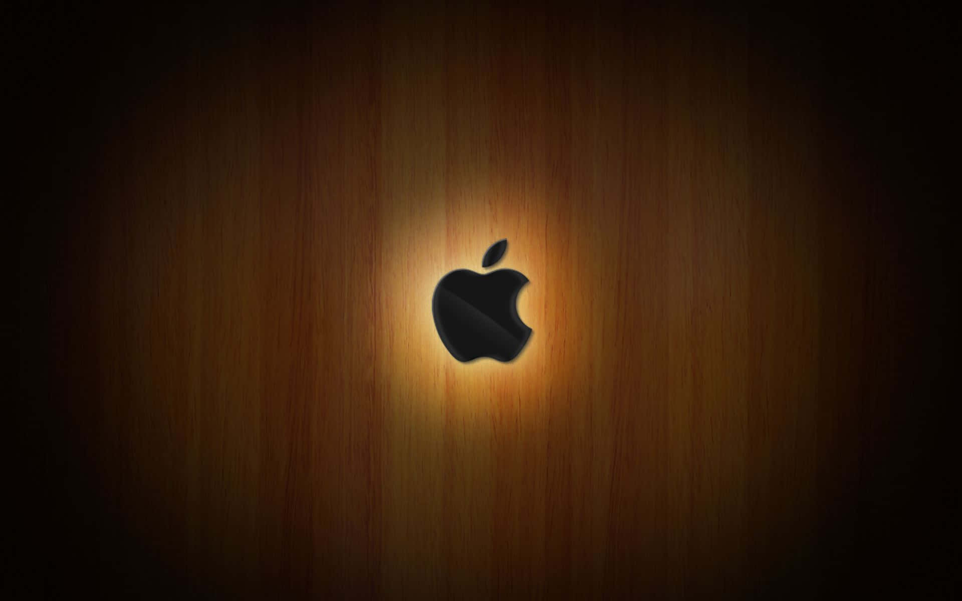 黑色Apple標誌在木質表面上發光，柔和光暈。 — 蘋果 壁紙