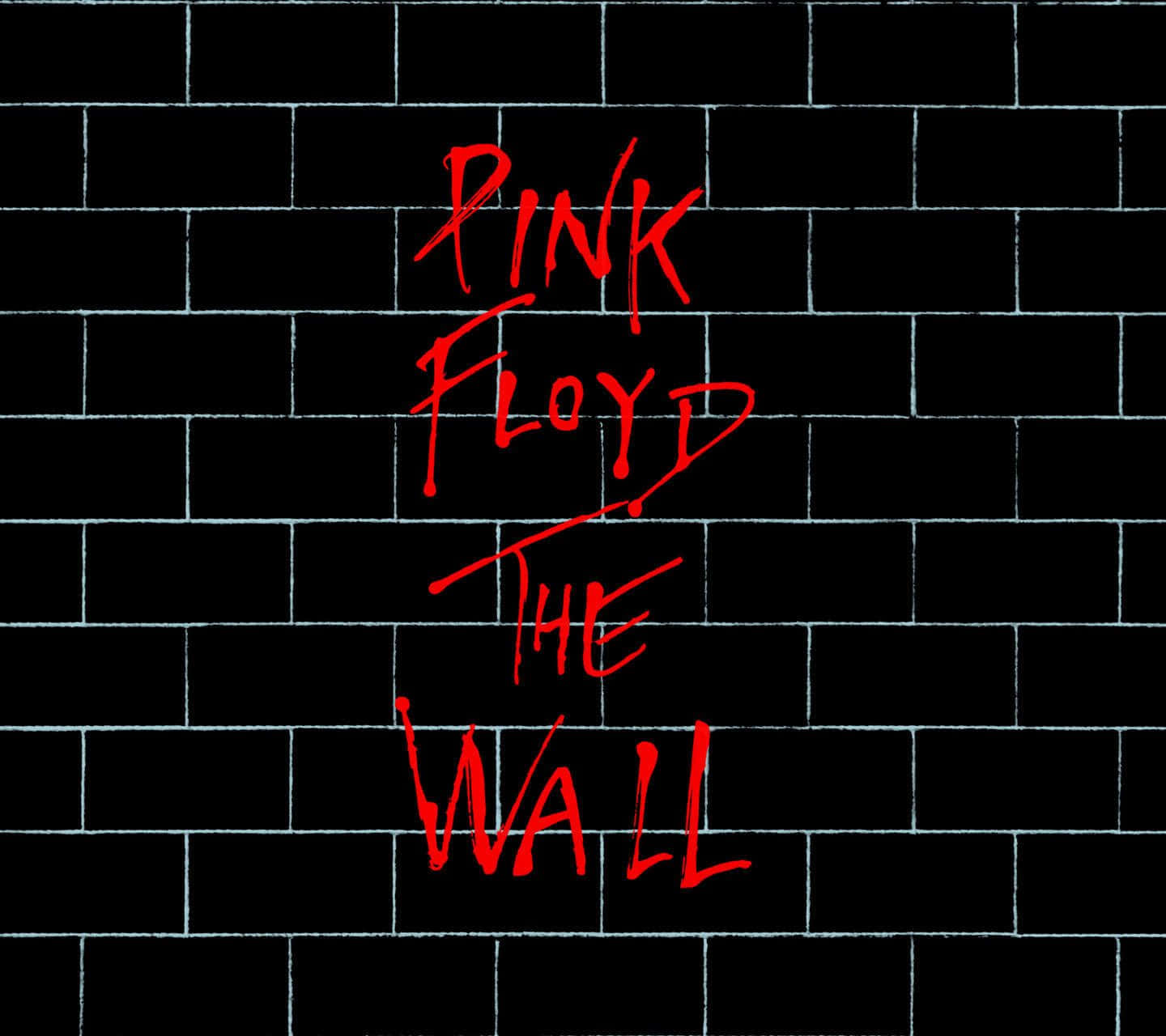 黑色磚牆上寫有 Pink Floyd The Wall 的紅色塗鴉文字。