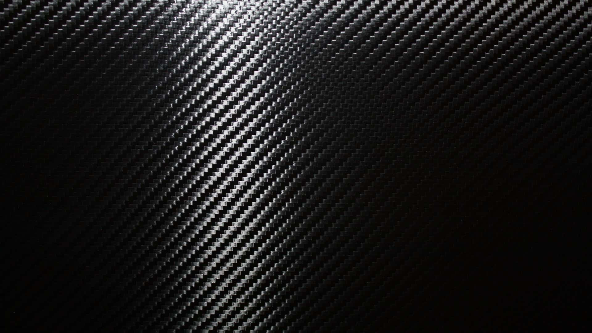 光澤黑色碳纖維紋理，帶有對角編織圖案。