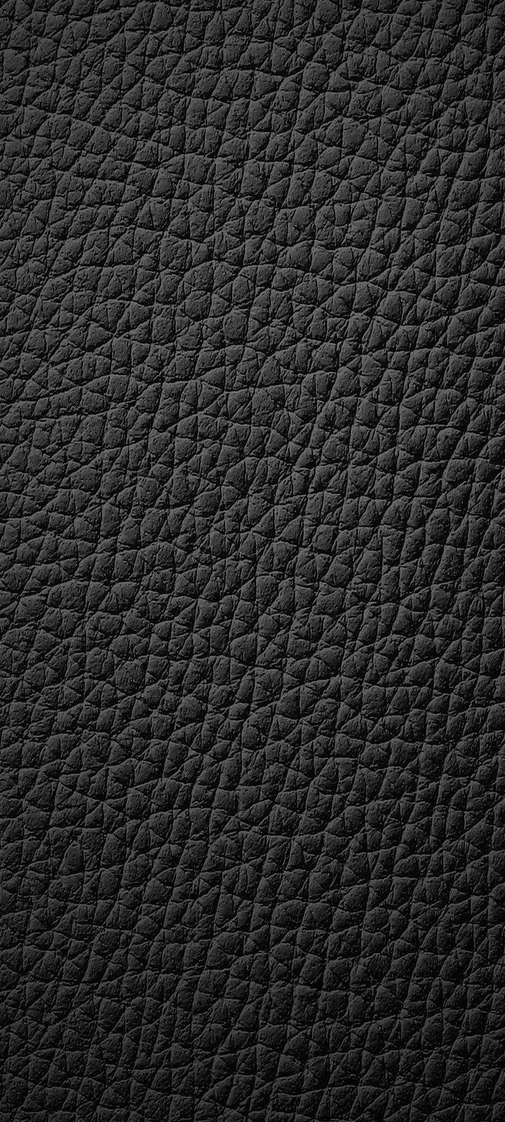 black textured 桌布 壁紙 — 黑色紋理皮革表面的特寫，具有深層紋理圖案和微妙光澤。