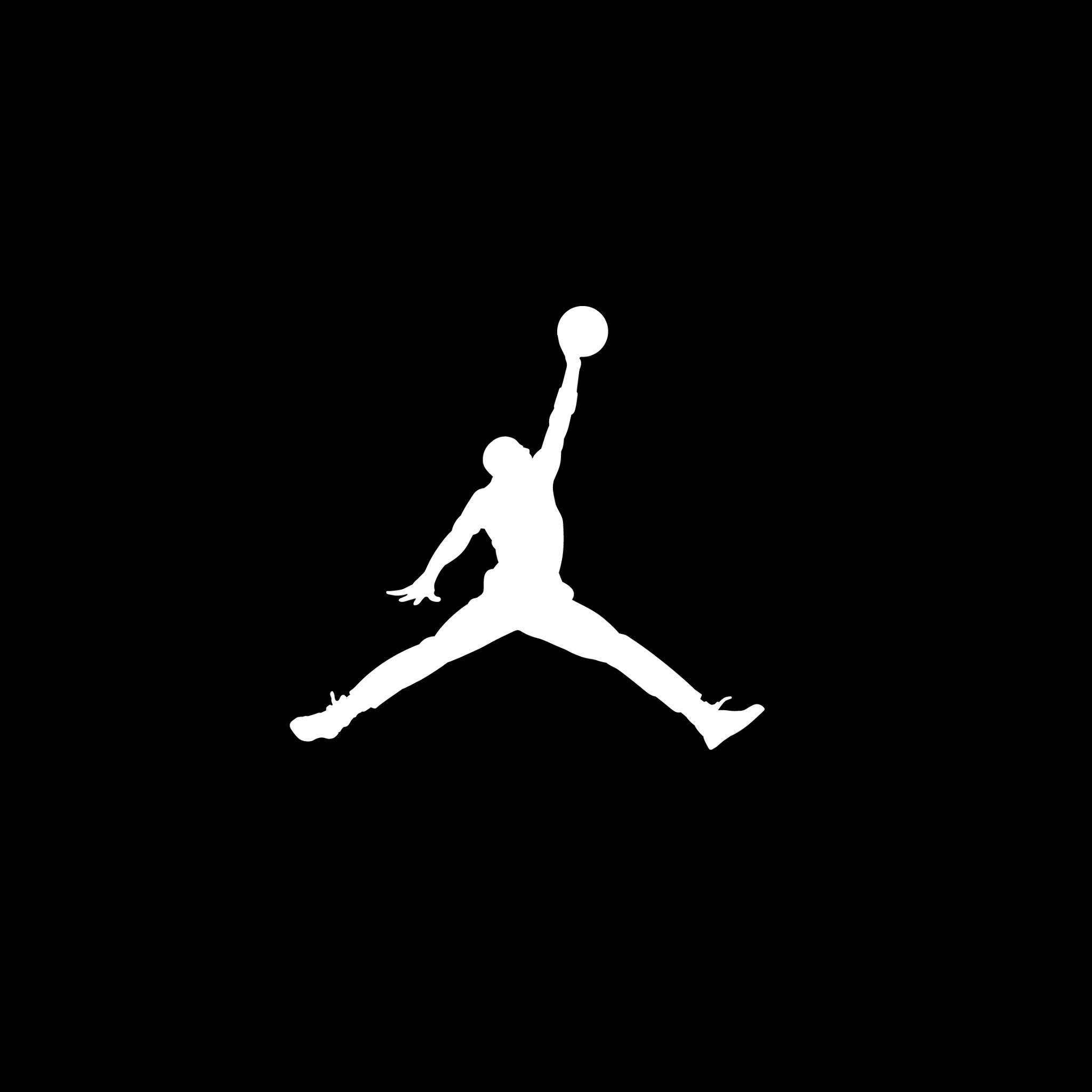 黑色背景Air Jordan 壁紙 — 一個籃球運動員在半空中入樽的鮮明白色剪影，背景為純黑色。