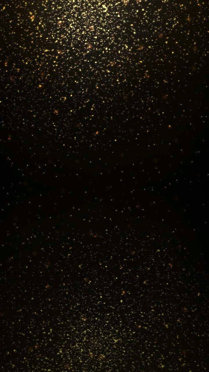 深色背景上金色閃粉顆粒如星星般閃爍。