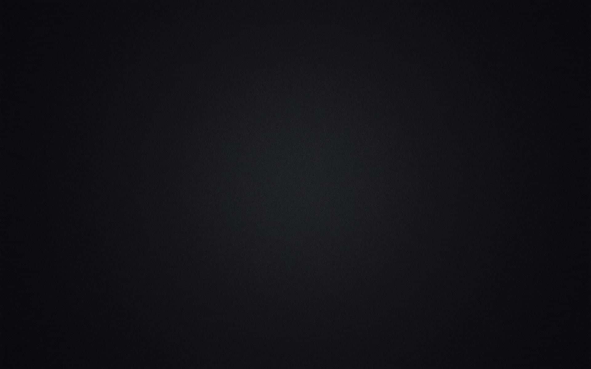 帶有柔和中心光暈的深色紋理背景，適合極簡設計。