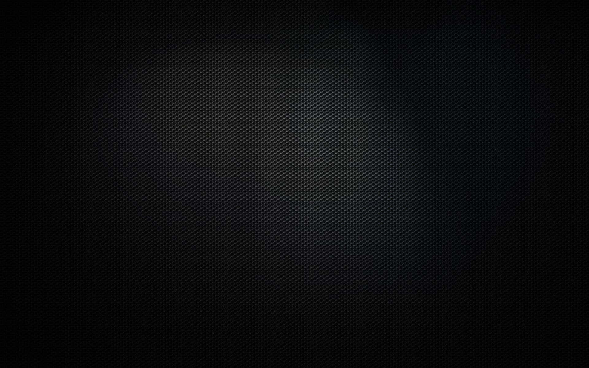 帶有柔和漸變聚光燈效果的深色紋理背景。