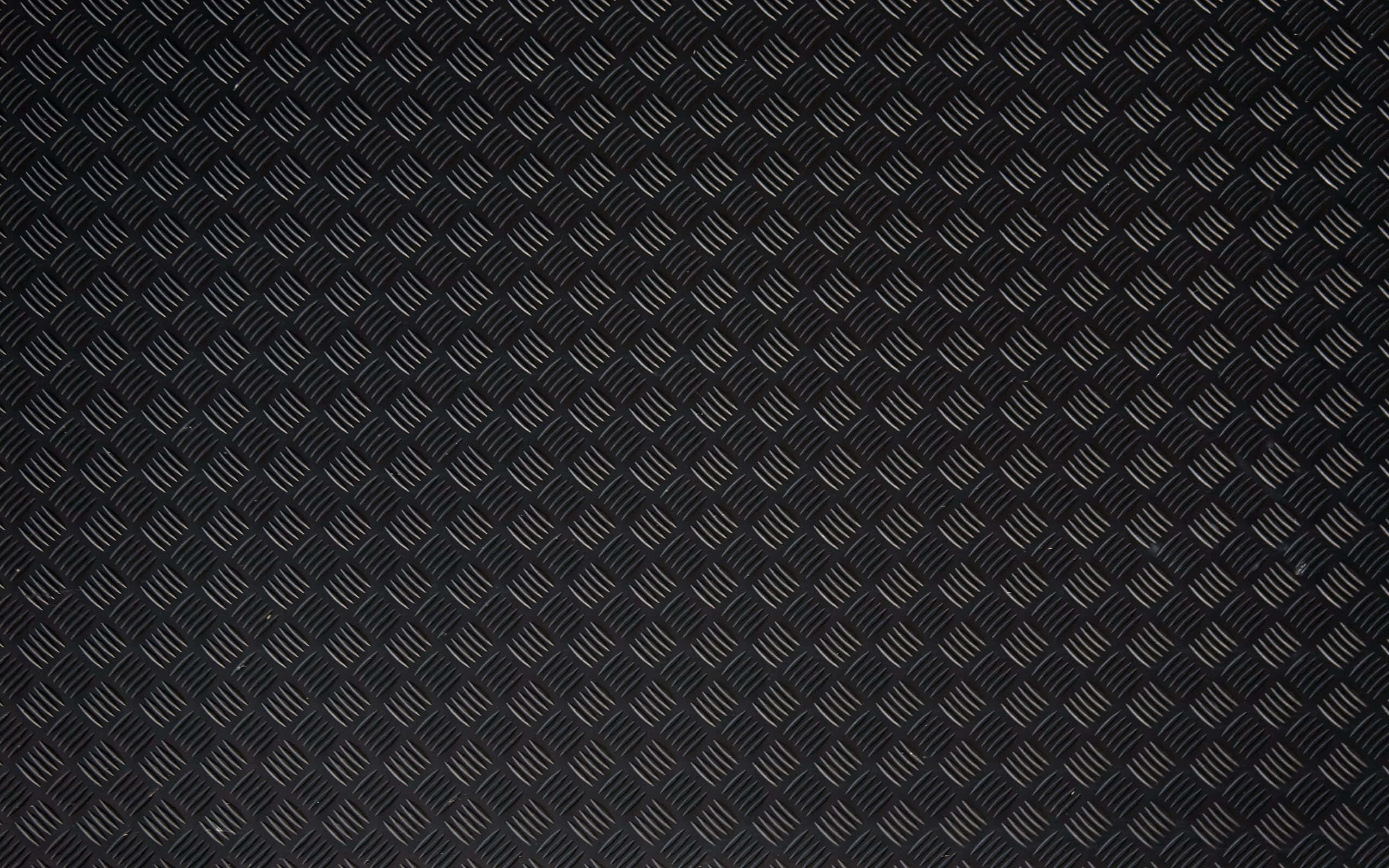 Diamond Plate 桌布 壁紙 — 黑色鑽石紋金屬表面的特寫，帶有微妙的光線反射。