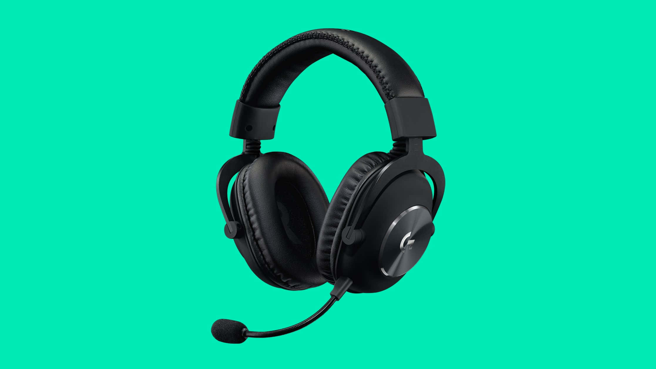 Gaming Headsets 桌布 壁紙 — 黑色頭戴式遊戲耳機連麥克風，襯托鮮豔藍綠色背景。