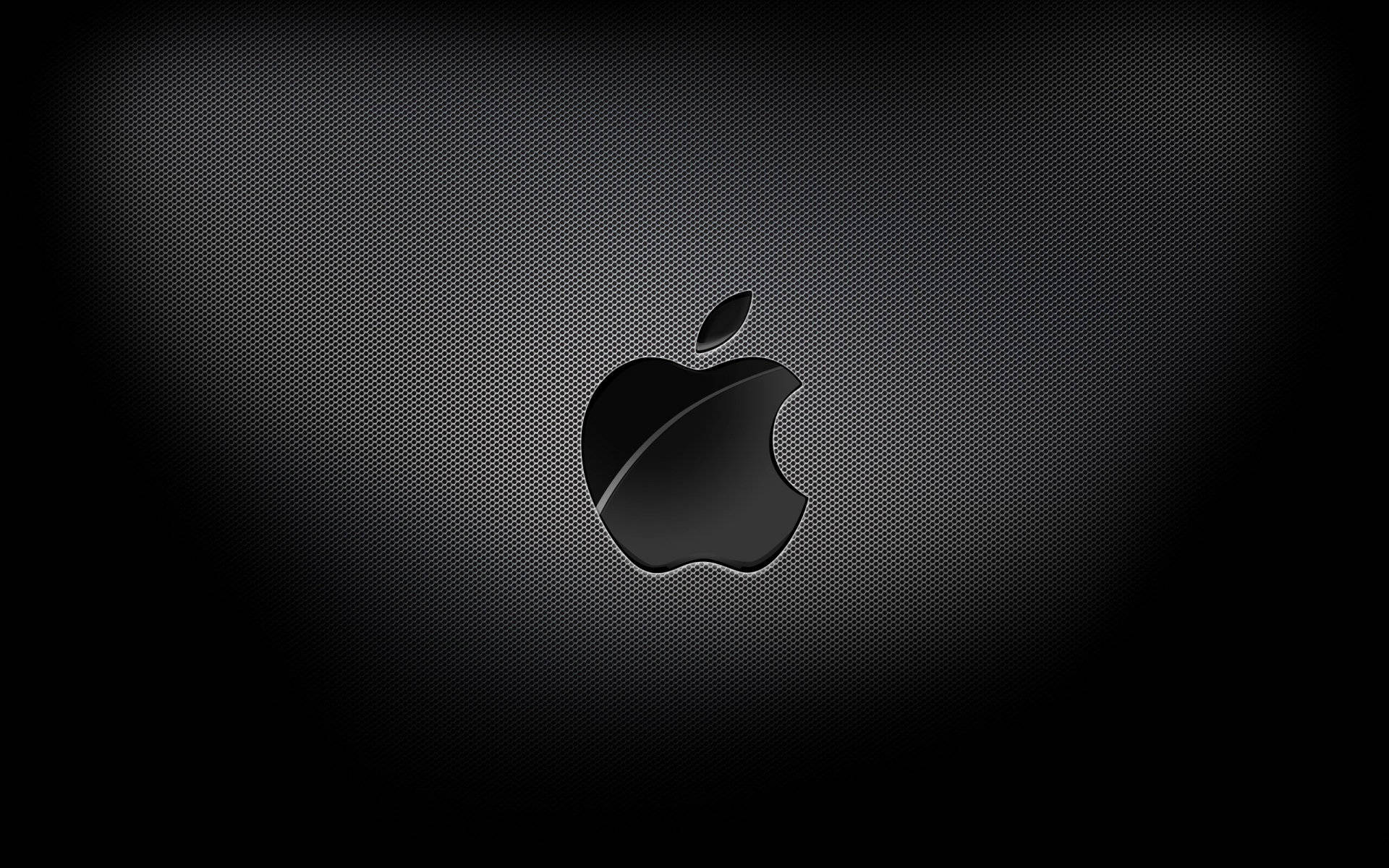 黑銀蘋果 macOS 壁紙 — 一個時尚的黑色Apple標誌居中於深色紋理背景上，帶有微妙的漸變照明。