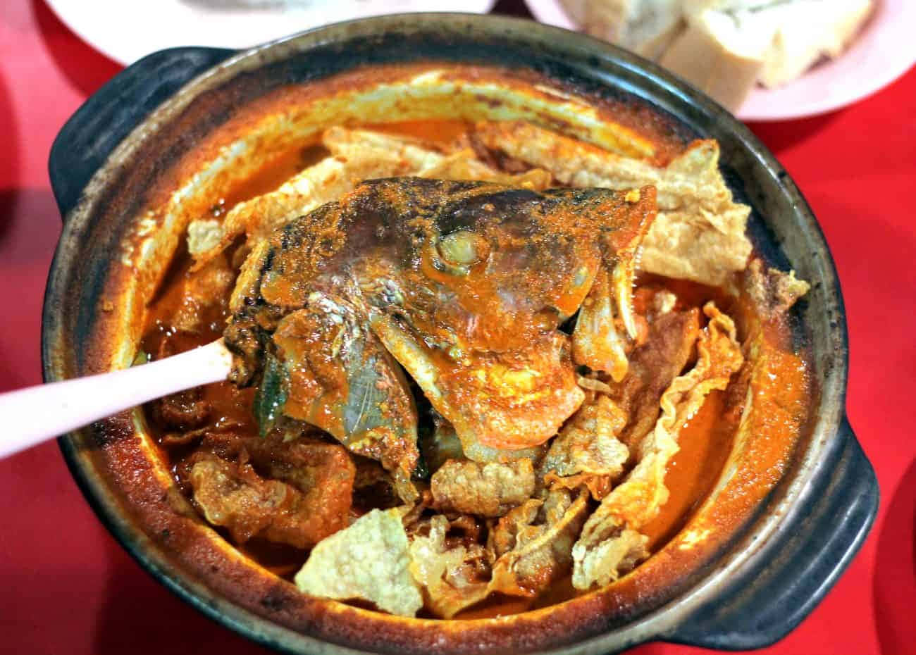 冒煙的砂鍋，裝有辣味印尼咖哩魚頭和脆皮豆腐。