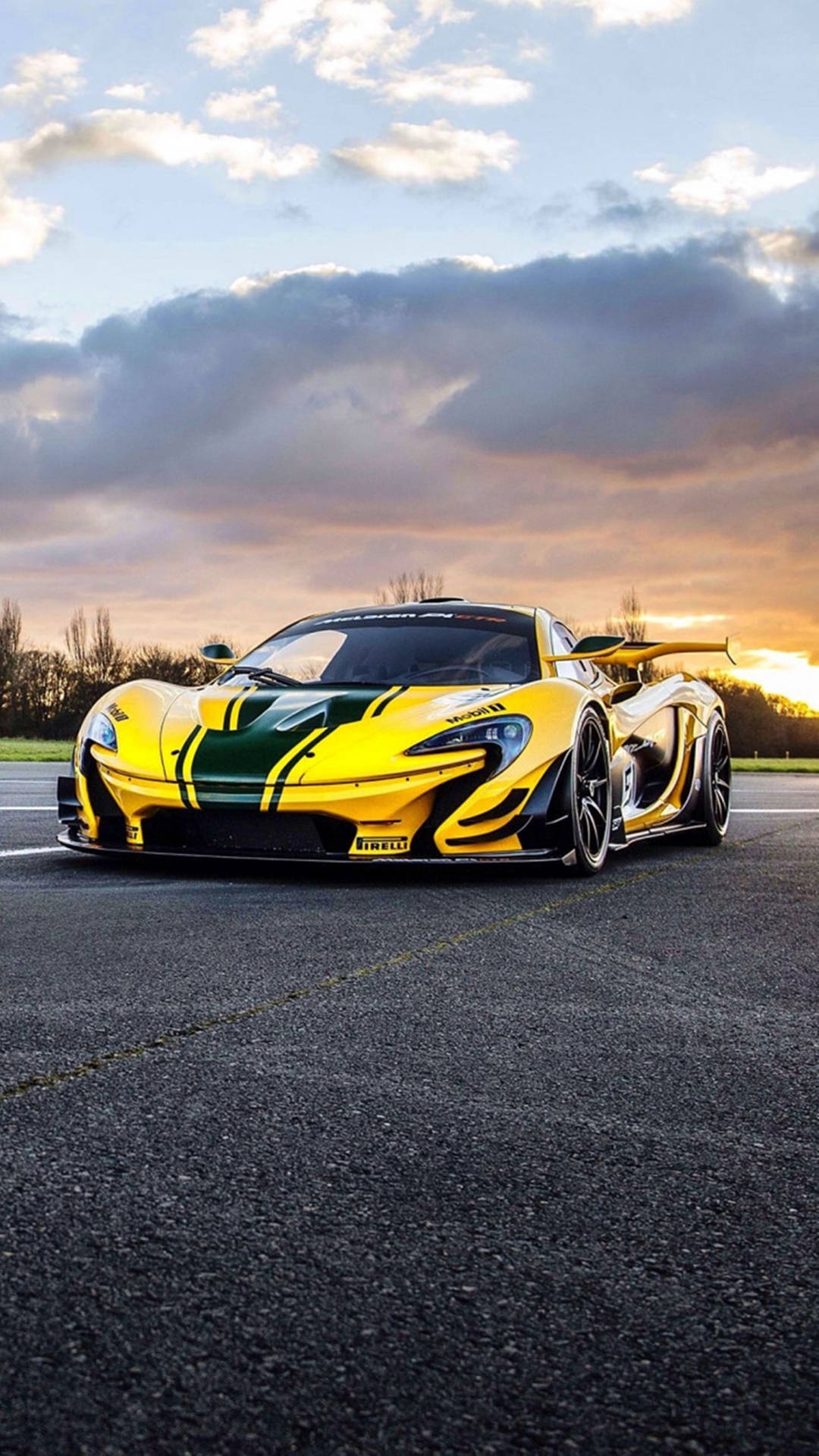 黃綠色McLaren P1超級跑車在瀝青賽道上，日落時分。