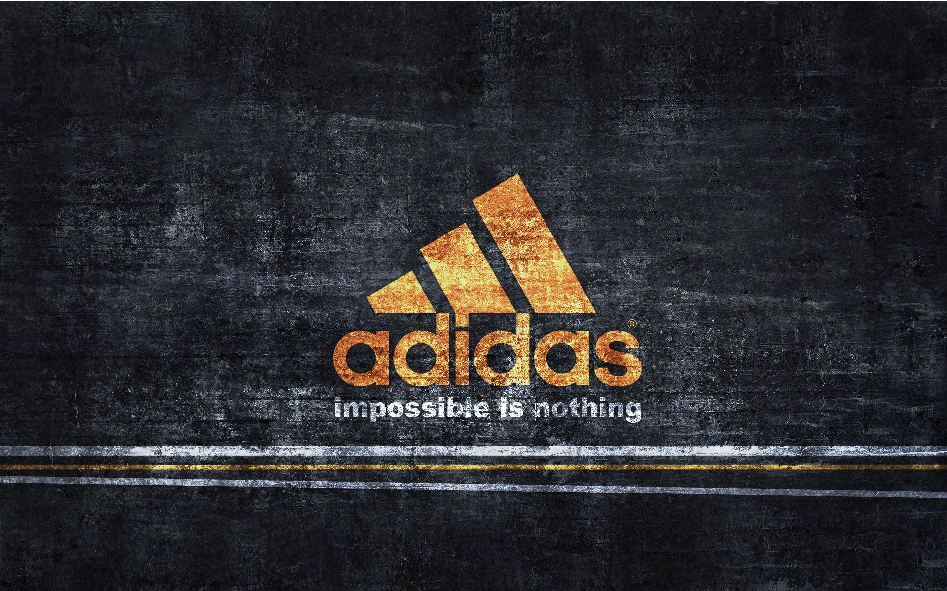 深色紋理牆上的Adidas標誌及口號impossible is nothing。