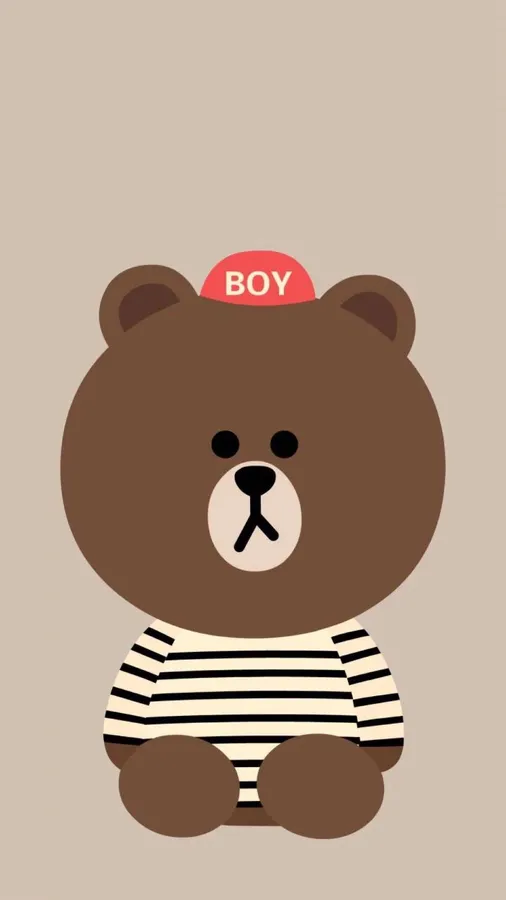 一隻穿著條紋襯衫和紅色帽子、上面寫著BOY的卡通熊。