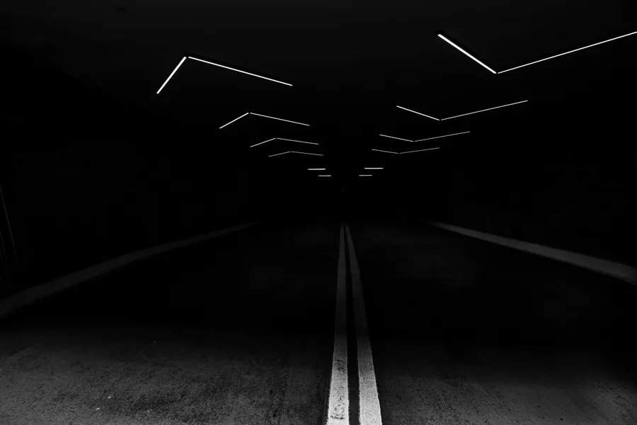 黑暗隧道,發光白色燈光及馬路中心線