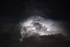 戲劇性的雷暴雲，在繁星點點的夜空下被閃電照亮。