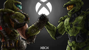 兩名身穿綠色盔甲的Halo士兵在Xbox標誌下碰拳。 — 毀滅戰士 壁紙
