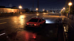 紅色汽車在夜晚停放在潮濕的城市街道上，下方有明亮的街燈。