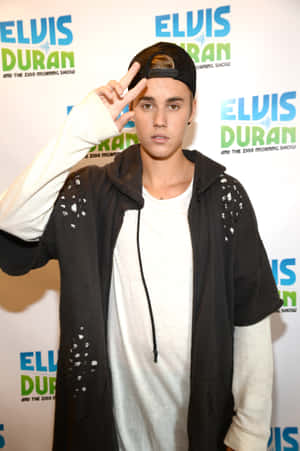 Justin Bieber 在 Elvis Duran 晨間節目活動中做出和平手勢。