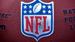 NFL標誌縫在橄欖球上，帶有可見的品牌文字和皮革質感。