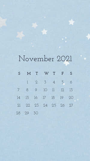 2021年11月月曆，白色星星點綴在淺藍色紋理背景上。