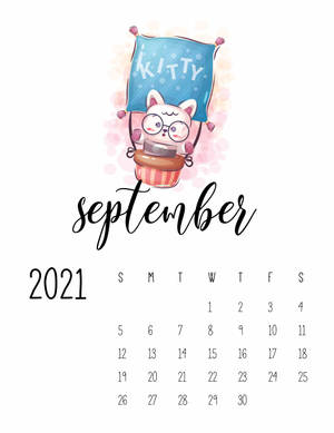 一隻卡通貓在紙杯蛋糕形狀的熱氣球中，位於 2021 年 9 月的日曆上方。