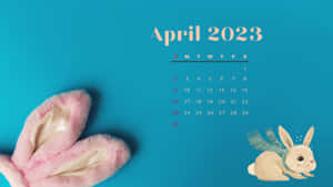 2023年4月日曆，帶有粉紅色兔耳朵和戴著圍巾的插圖兔子，青綠色背景。 — 日曆 壁紙