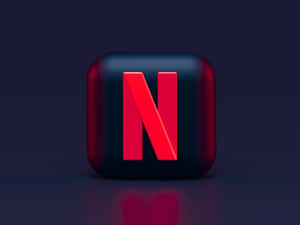 光滑黑色立方體，帶紅色Netflix標誌，置於深色反光表面。