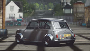 銀色經典Mini Cooper S賽車在工業庭院中，背景有石頭建築。 — 極限競速：地平線4 壁紙