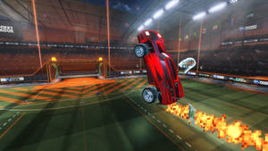 紅色汽車在Rocket League競技場中翻轉，帶像素火焰 — 火箭聯盟 GIF 壁紙