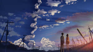 兩個人在日落時分的田野裡觀看雲彩和電線