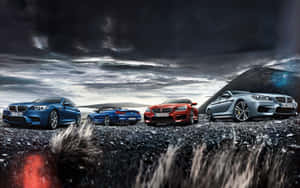 四輛BMW跑車停在火山礫石上，天空風起雲湧。
