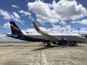 俄航飛機停在機場停機坪，天空晴朗有雲