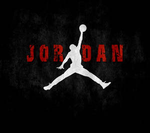 白色籃球運動員剪影跳起持球，位於黑色背景上的紅色「JORDAN」文字上方。 — Air Jordan GIF 壁紙