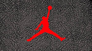 紅色籃球運動員剪影在灰色紋理背景上持球跳躍。 — Air Jordan GIF 壁紙