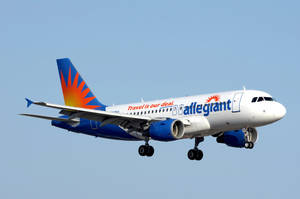 Allegiant Airlines 飛機帶太陽標誌在藍天飛行